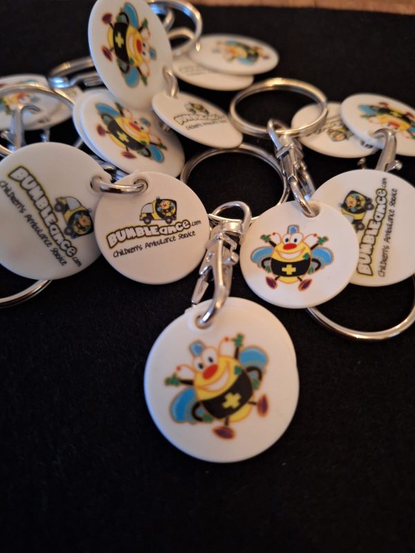 A pile of BUMBLEance Trolley Token Keyrings
